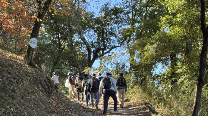 Picking up trash while hiking a mountain trail
